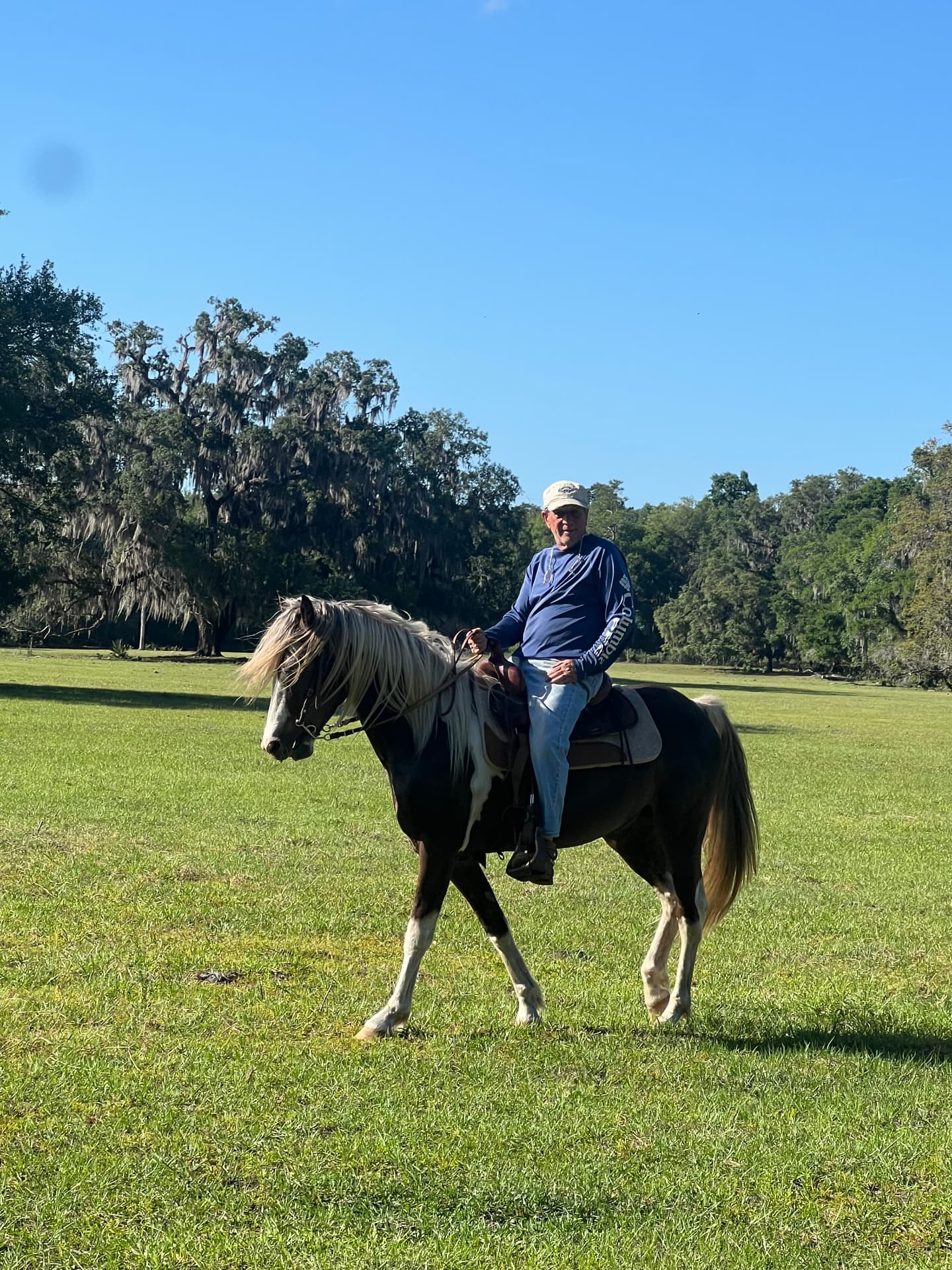 Ziggy, owner of Ziggy's Fine Painting, riding his horse in a Florida pasture